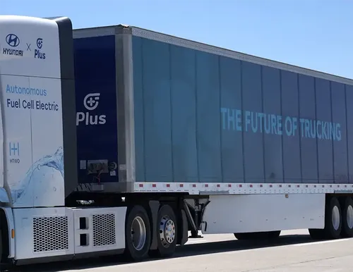 Side view of a Hyundai XCIENT Fuel Cell Electric truck featuring the text 'THE FUTURE OF TRUCKING' on the trailer, highlighting hydrogen-powered technology