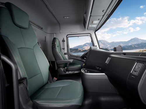 Interior cabin of the Hyundai XCIENT, showcasing 10-way adjustable seat with 3-stage seat cooling and heating